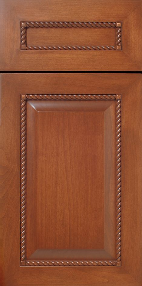 Wooden kitchen cabinet door with rope-like molding around a recessed panel.