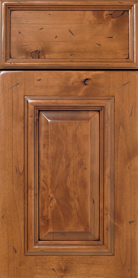 Wooden cabinet door with raised panel. Warm brown color with visible wood grain and knots.
