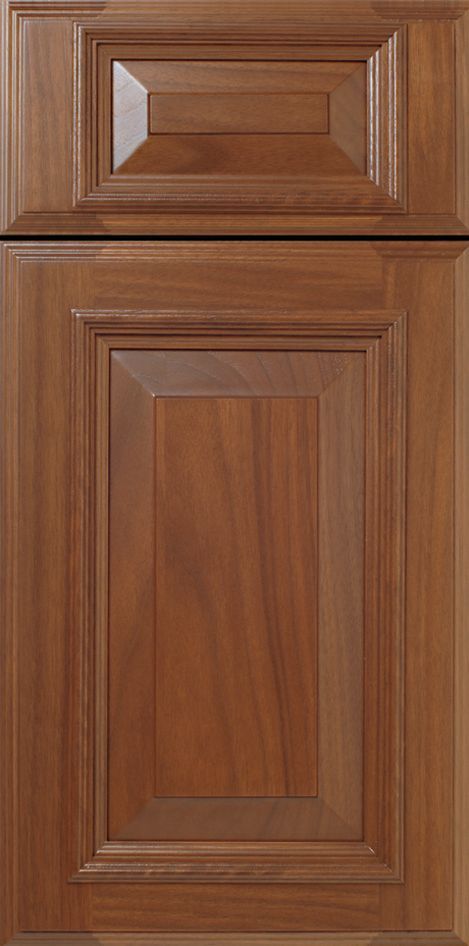 Wooden kitchen cabinet door with raised paneling and warm brown color.
