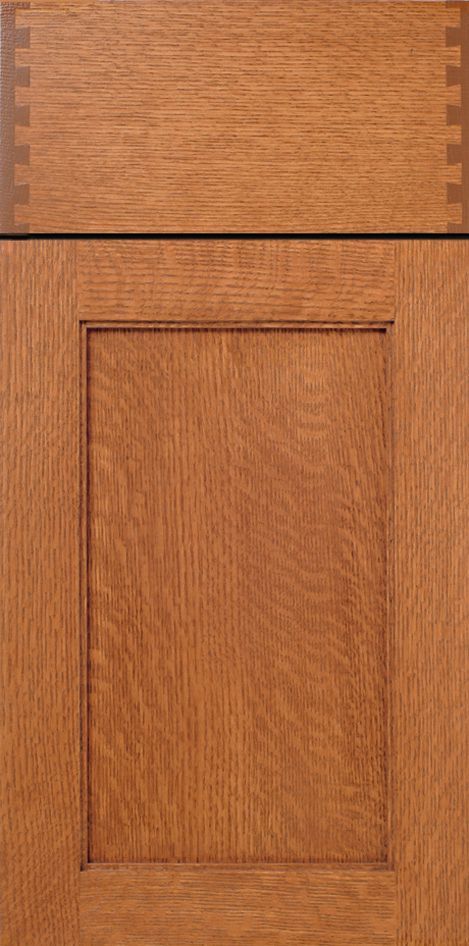 Close-up of a stained wooden cabinet door, showing the grain and joinery.