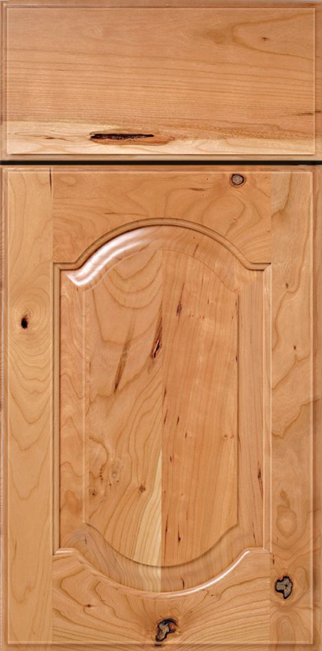 Wooden kitchen cabinet with arched panel and natural wood grain.