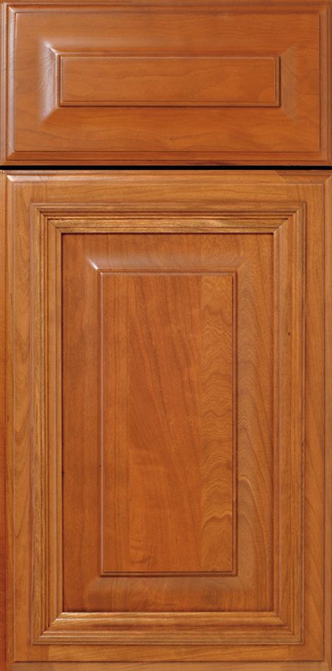 Wooden cabinet door with raised panels, stained in warm brown tones.