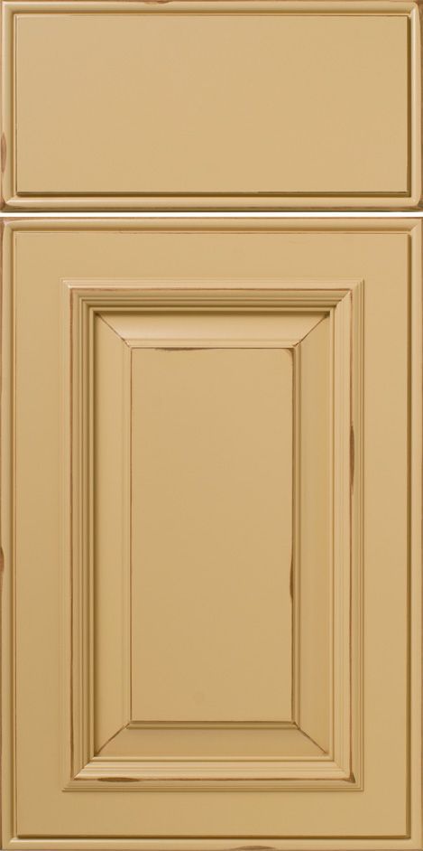 Beige cabinet door with raised panel and decorative trim.