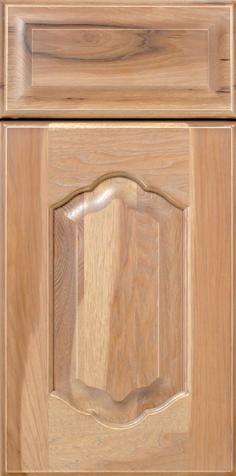 Light wood kitchen cabinet door with ornate central panel.