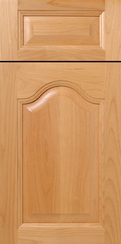 Light-colored wooden cabinet door with raised panel and curved top detail, and rectangular door above.