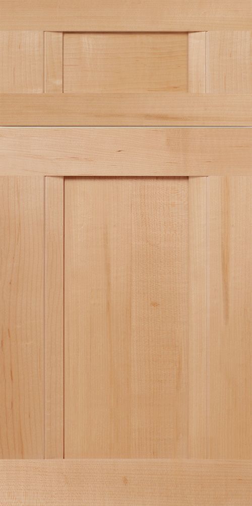 Wooden cabinet door with light brown grain. Recessed panel.