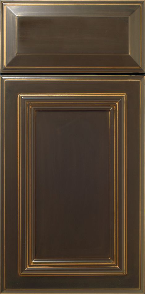Brown kitchen cabinet door with raised panel and decorative trim.