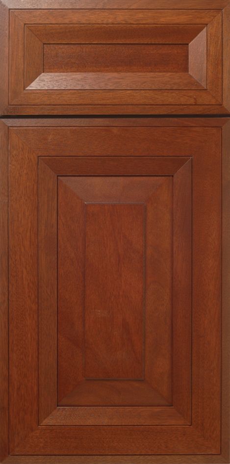Close-up of a wooden cabinet door with a raised panel and rich brown finish.