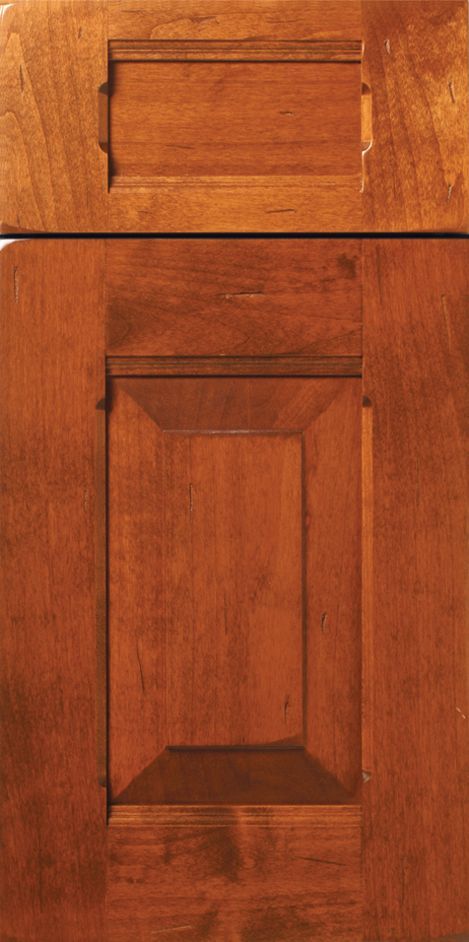 Wooden cabinet doors with rectangular raised panels, stained in a warm brown tone.