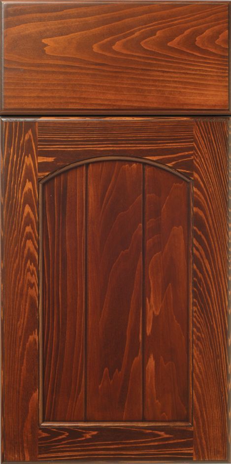 Dark wood cabinet door with arch detail and visible wood grain.