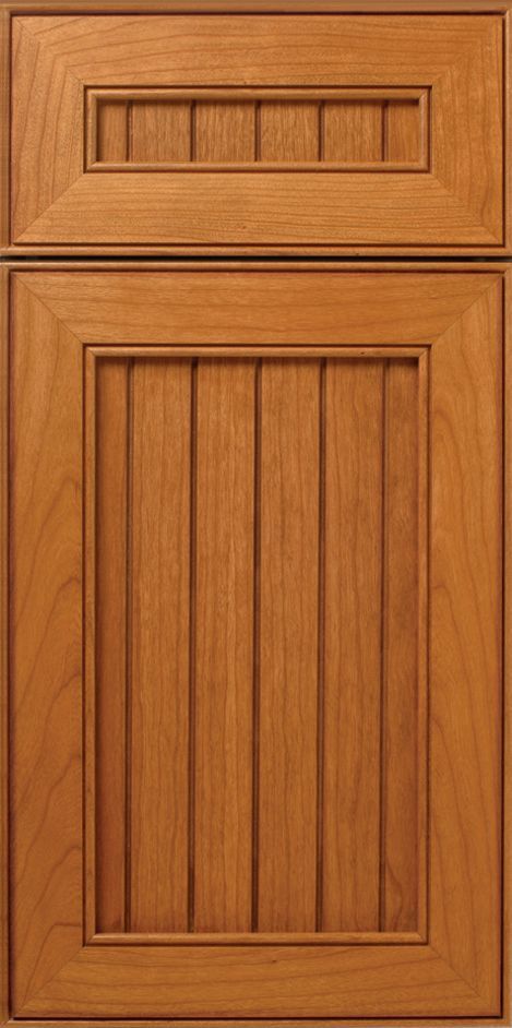 Wooden cabinet door with raised panel and vertical grooves.