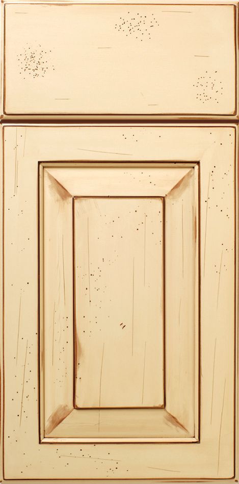 Cream-colored kitchen cabinet door with distressed paint and visible wood grain.