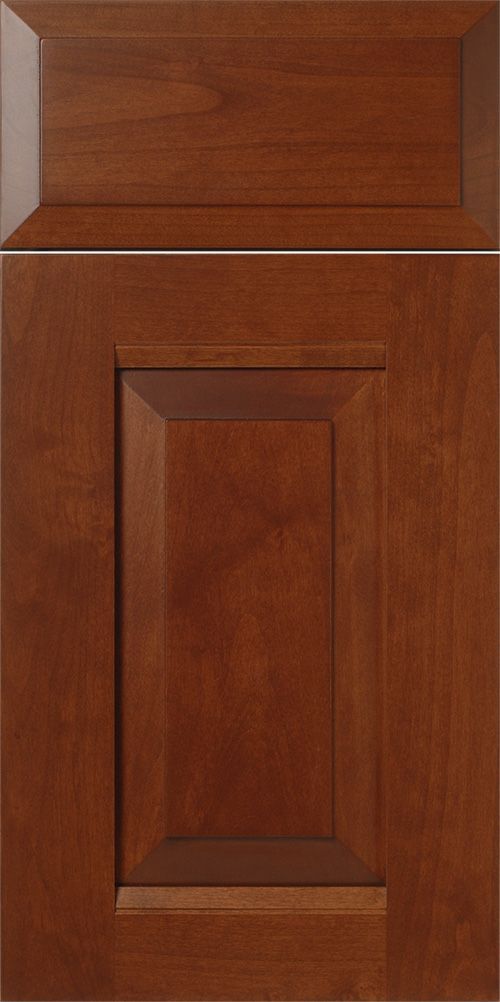 Close-up of a stained wooden cabinet door with raised panel and frame, in a warm brown color.