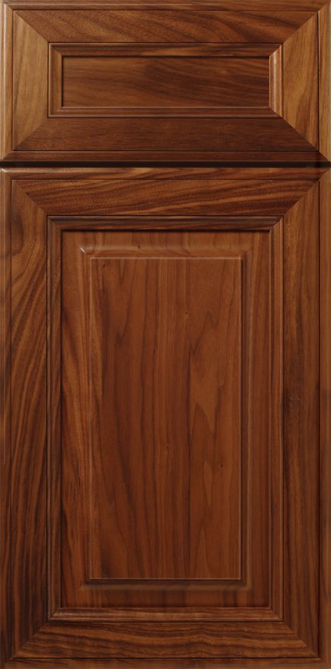 Wooden cabinet door with raised panel, stained brown.