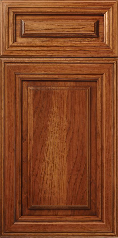 Wooden cabinet door with a brown finish and detailed paneling.