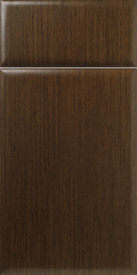 A close-up of a brown wood grain cabinet door with a raised panel.