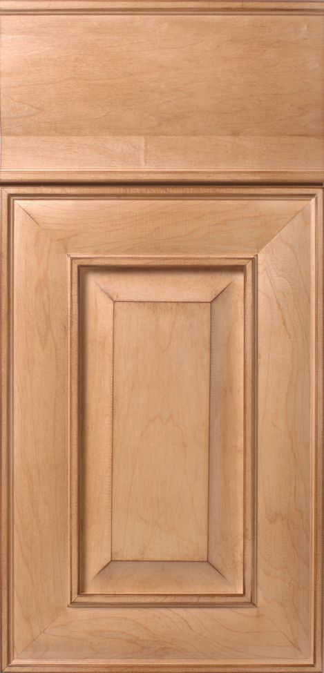 Light brown wooden cabinet door with raised panel and trim.