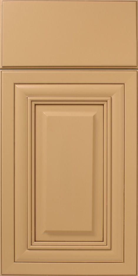 Tan kitchen cabinet door with recessed panel and decorative molding.