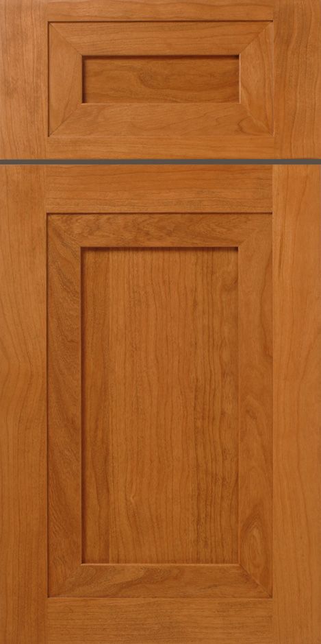Wooden kitchen cabinet door with a raised-panel design in shades of brown and orange.