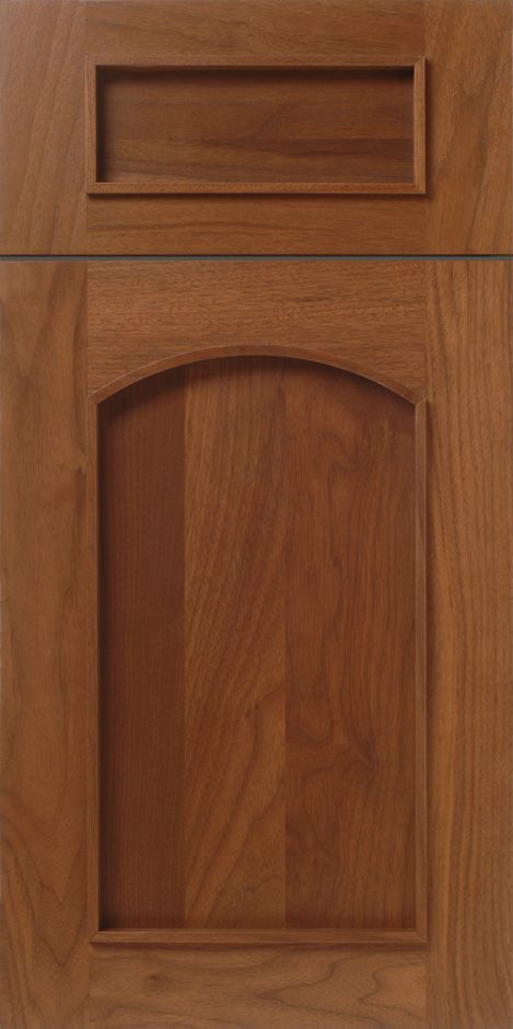 Wooden cabinet door with rectangular detail at the top and arched detail in the center.