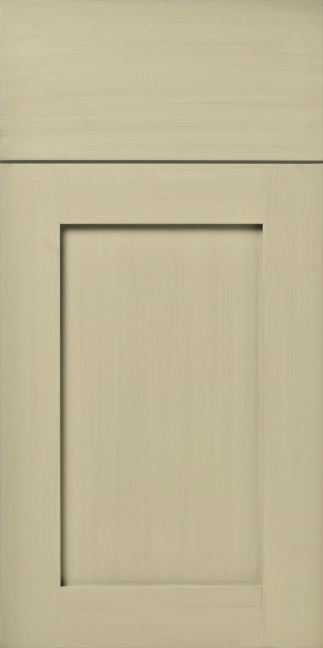 A close-up of a light olive green kitchen cabinet door, with a square recessed panel design.