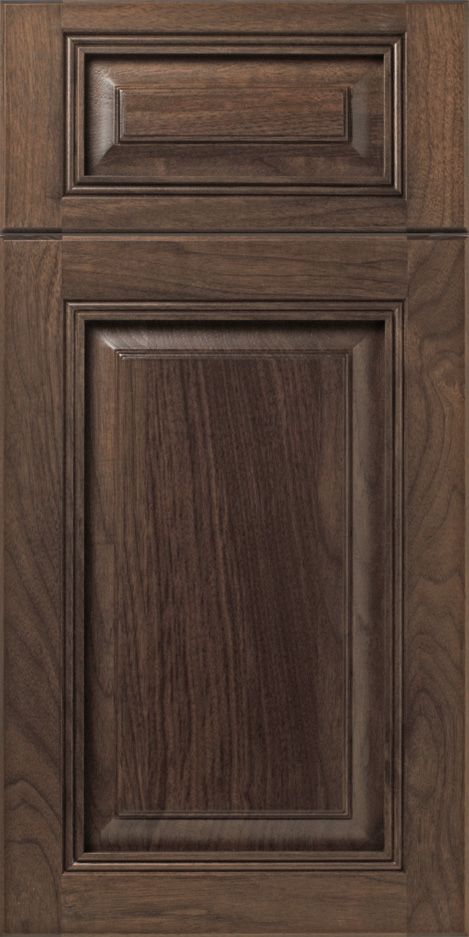 Dark brown, wood-grained kitchen cabinet door with recessed panels and detailed trim.