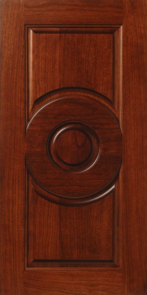 Wooden door with a circular, carved inset.