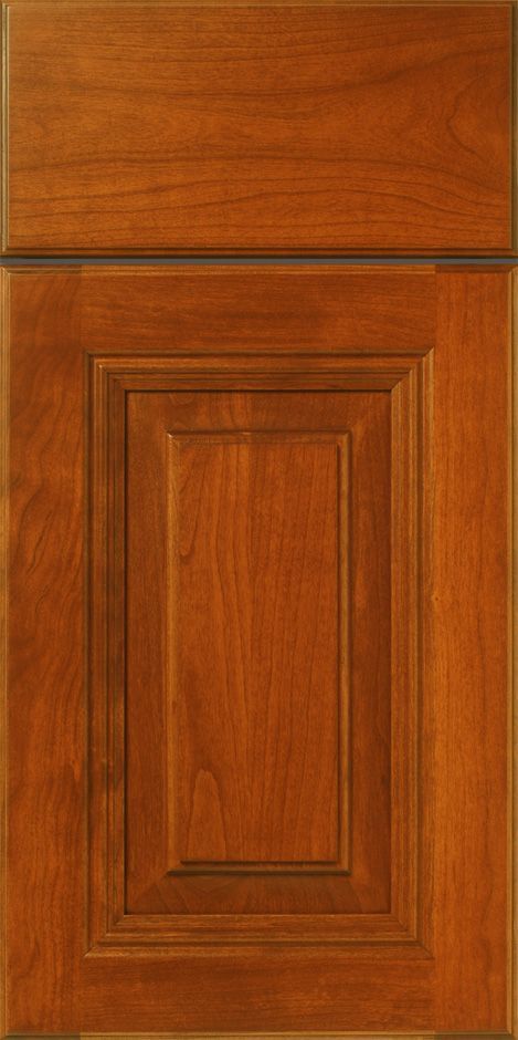 Wooden cabinet door with a raised panel design, stained in a warm brown color.