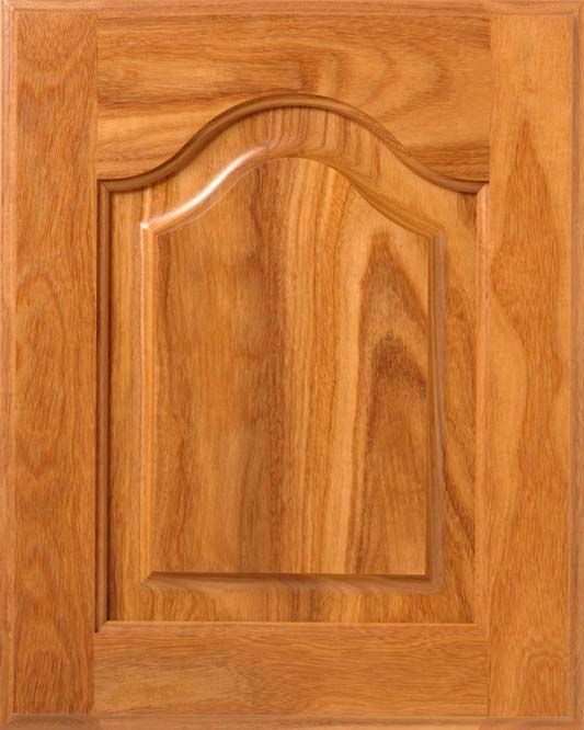 Wooden cabinet door with raised panel and arched top, stained golden brown.