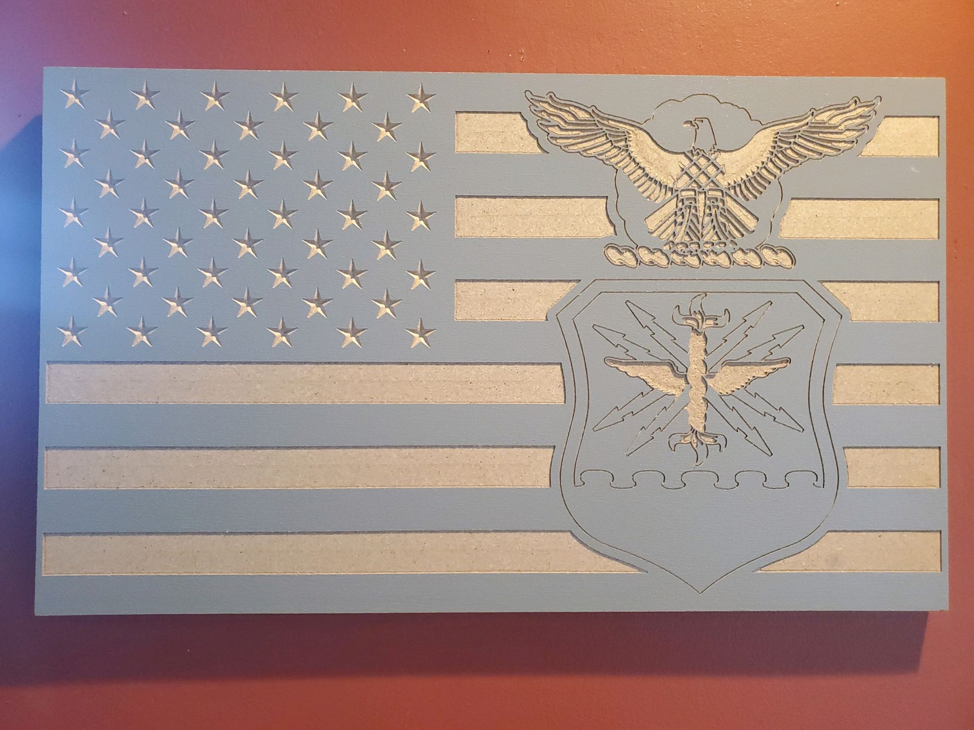 Wooden American flag with blue and silver details, including an Air Force emblem.