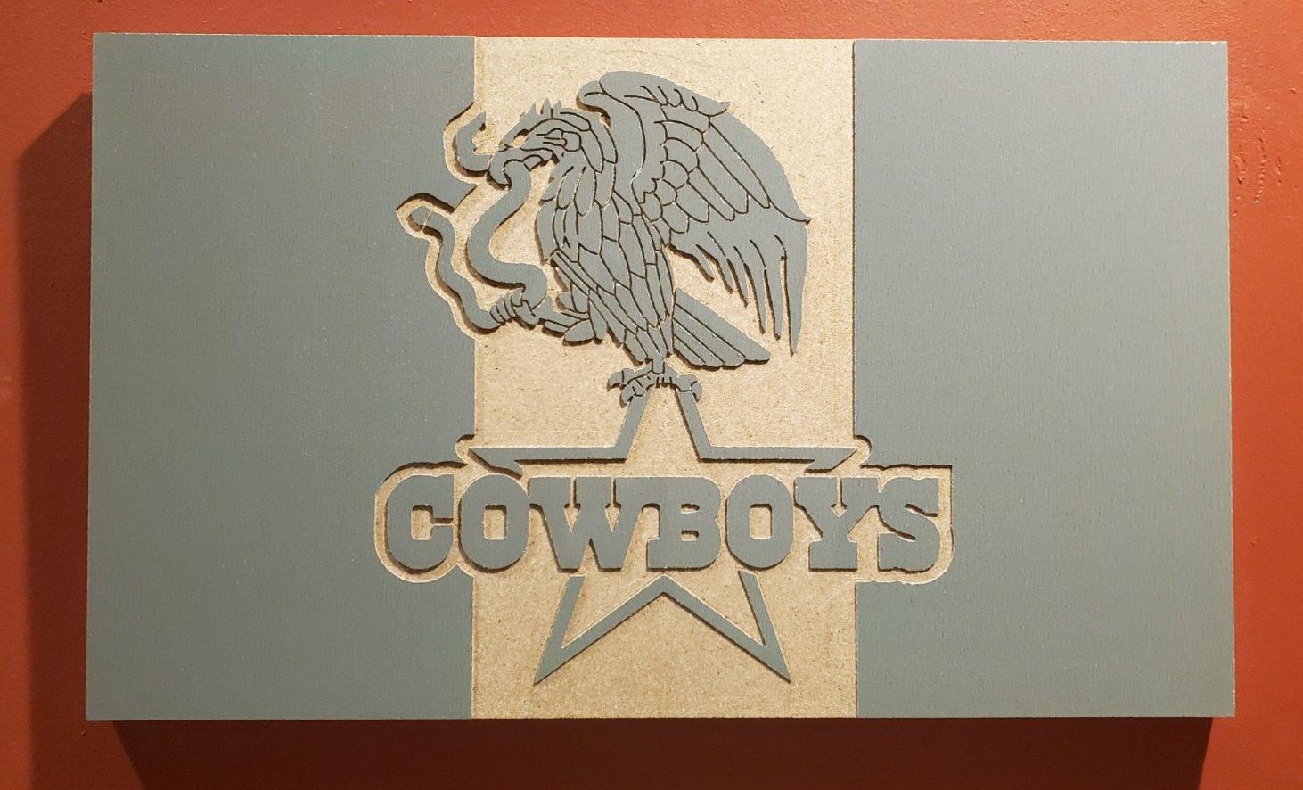 Wooden sign: Dallas Cowboys logo with eagle and text on blue and silver stripes.