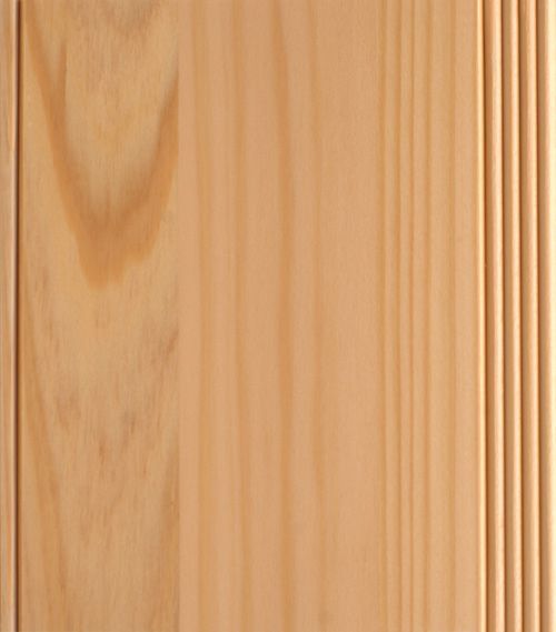 Wooden door panel with vertical grain and a decorative fluted edge.