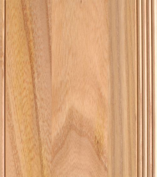 Close-up of wooden door panel with vertical grain and carved detail.