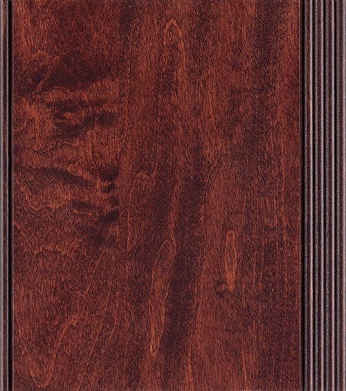Dark stained wood cabinet door with vertical grain and decorative edge.