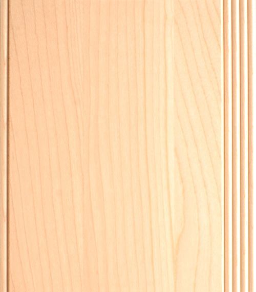 Light-colored wood cabinet door with vertical grain and a decorative grooved edge.