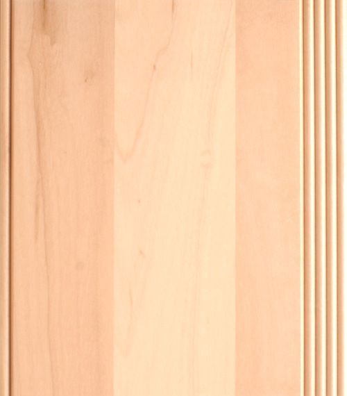 Light-colored wood cabinet door with vertical panels and decorative, ridged edge.