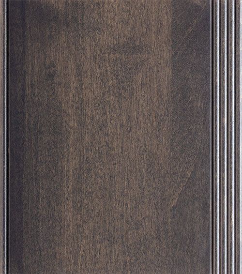 Dark stained wood cabinet door with vertical grain and decorative trim.