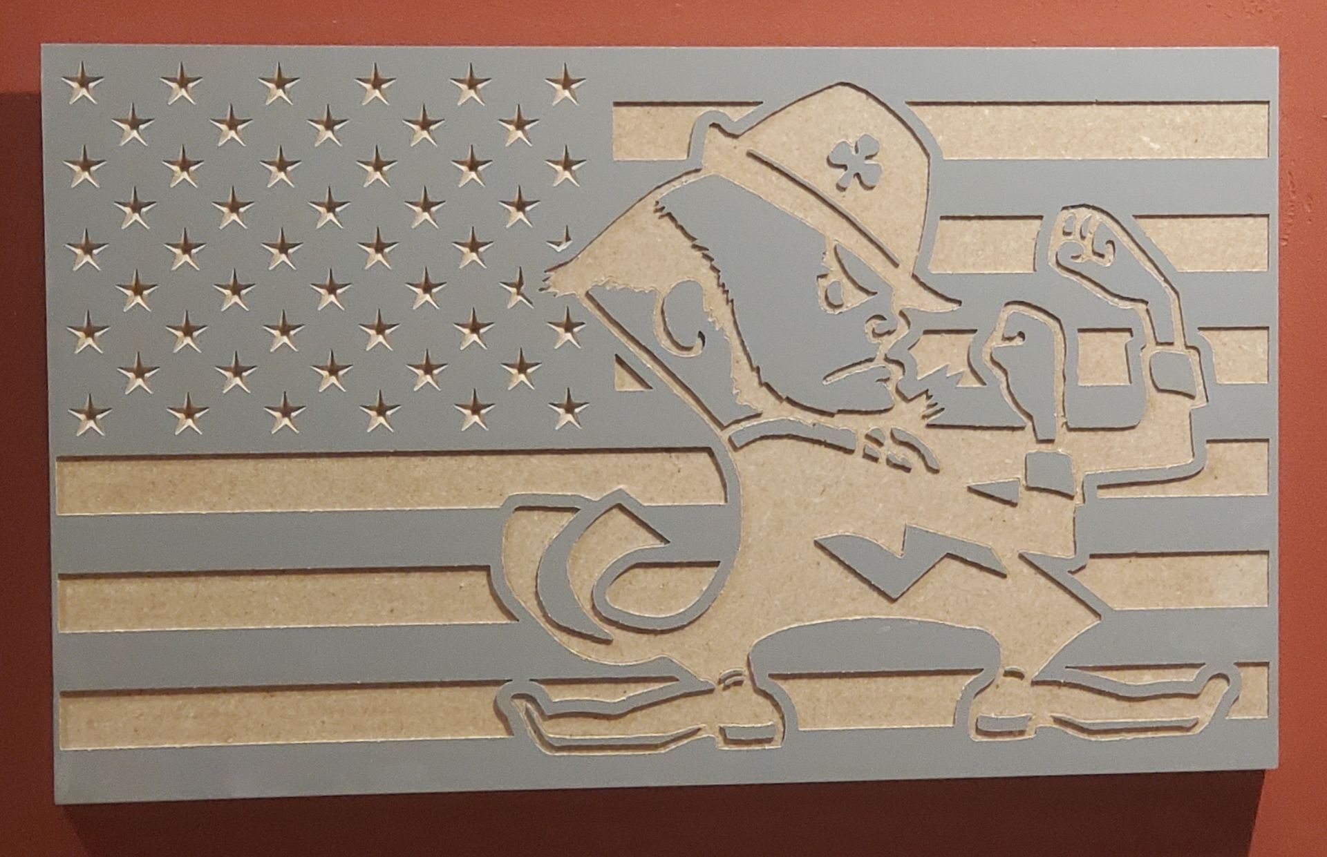 Notre Dame Fighting Irish logo on American flag wood carving.
