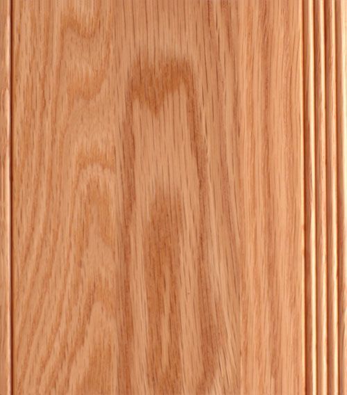 Close-up of reddish-brown wood panel with vertical grain and grooved edge detail.