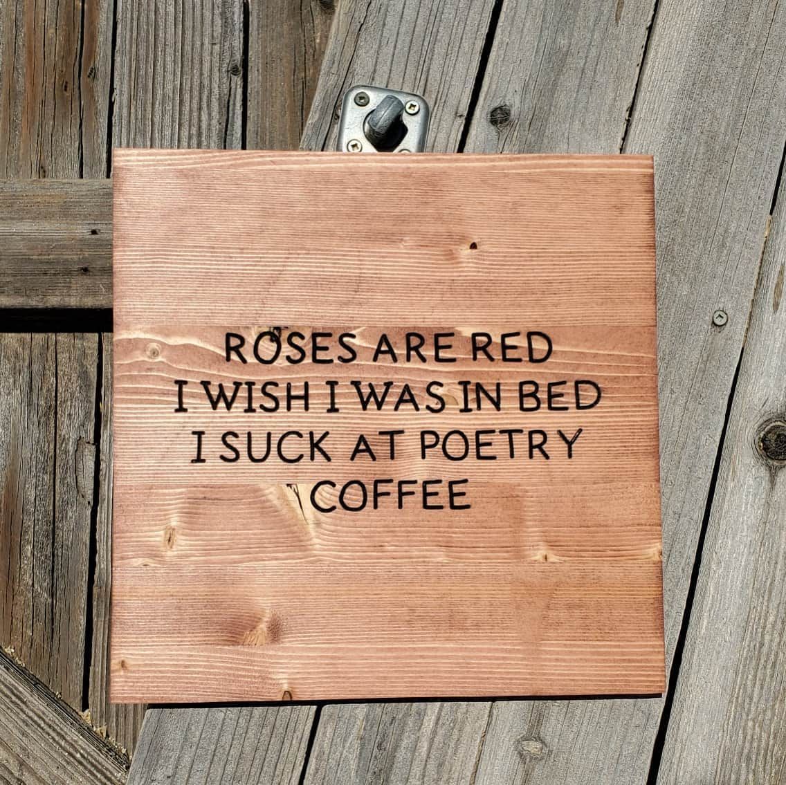 Wooden sign with carved words: