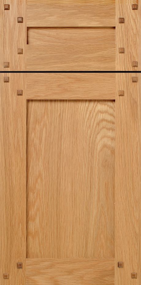 Close-up of two wooden cabinet doors, with decorative wood joinery and natural wood grain.