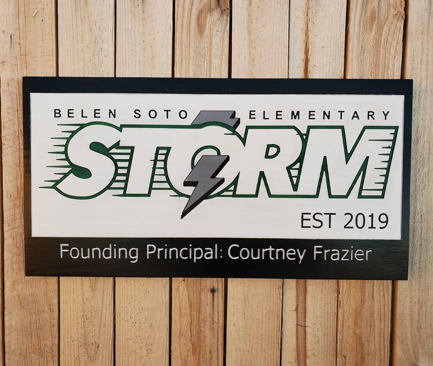 Sign for Belen Soto Elementary school, white background, green and gray