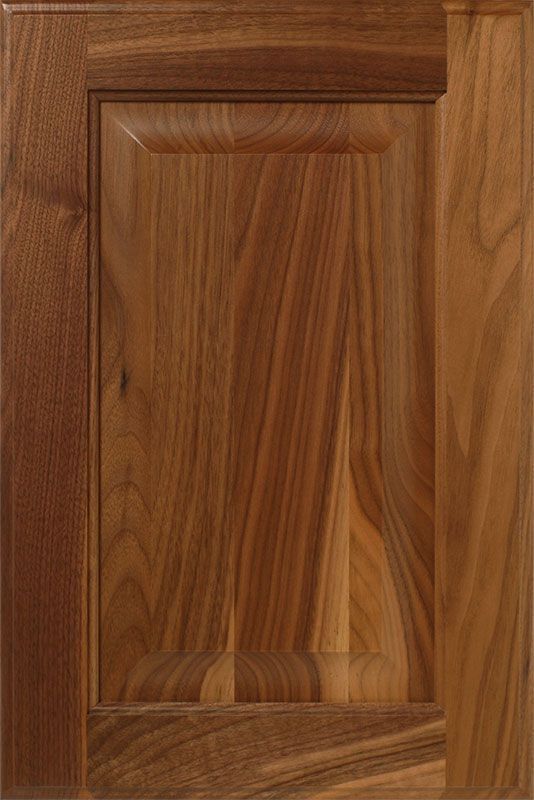 Wooden cabinet door with raised panel and wood grain.