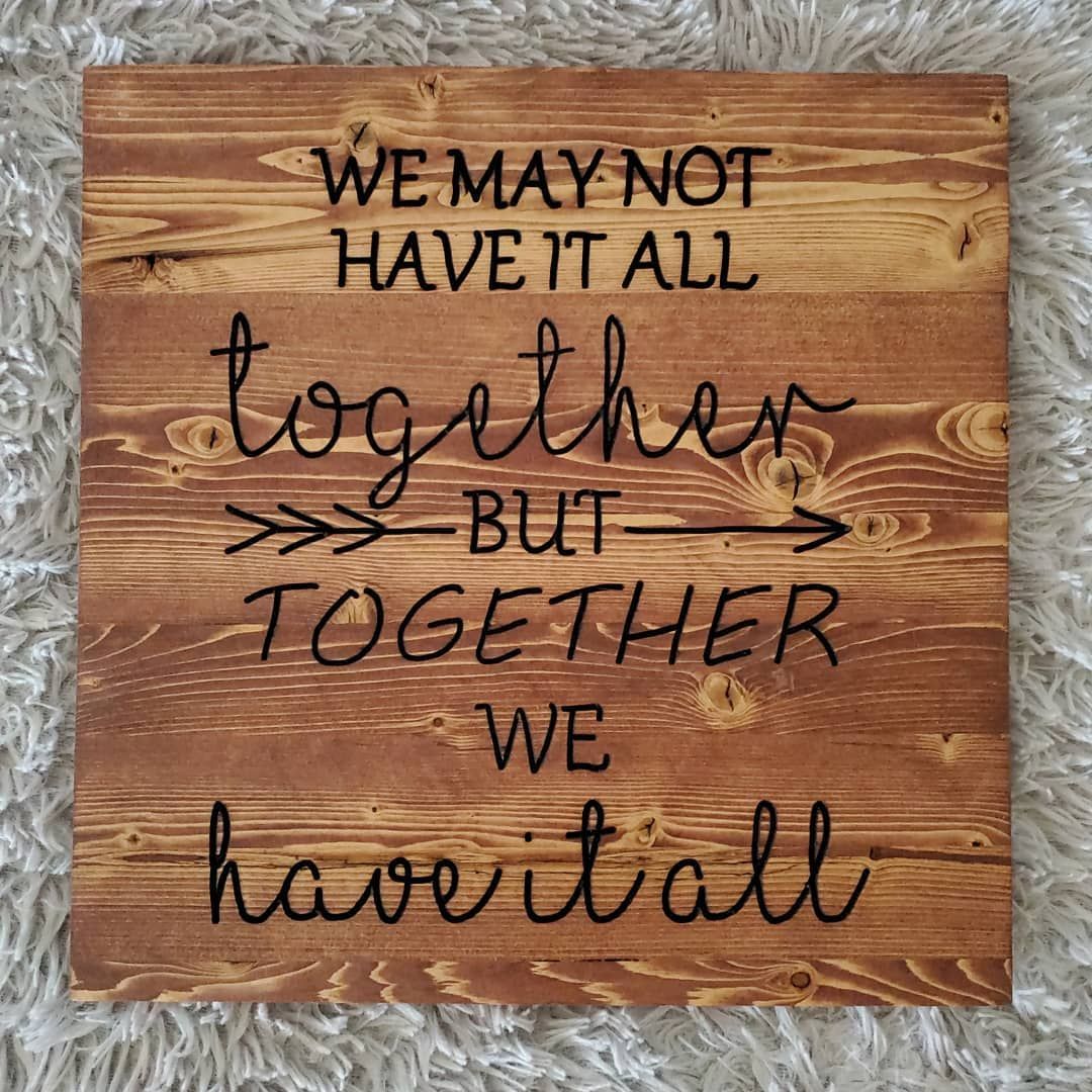 Wooden sign with dark text: