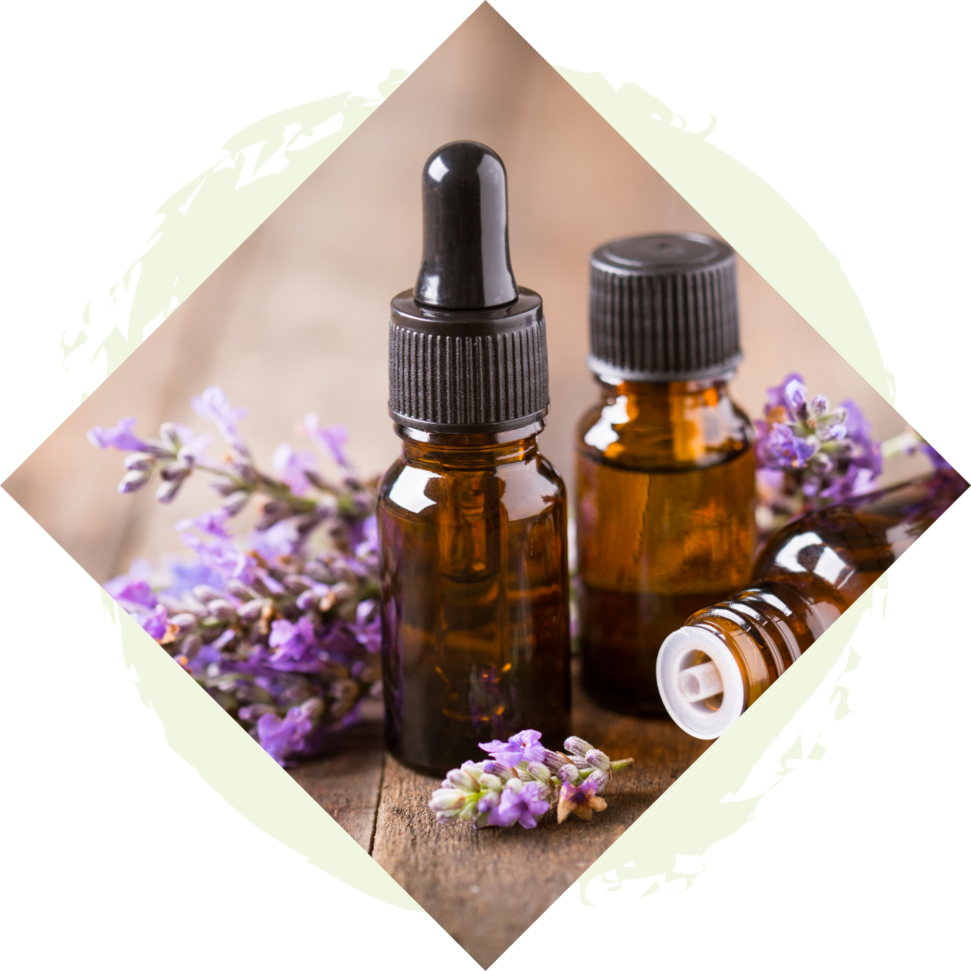 Three bottles of essential oil with purple flowers on a wooden table.