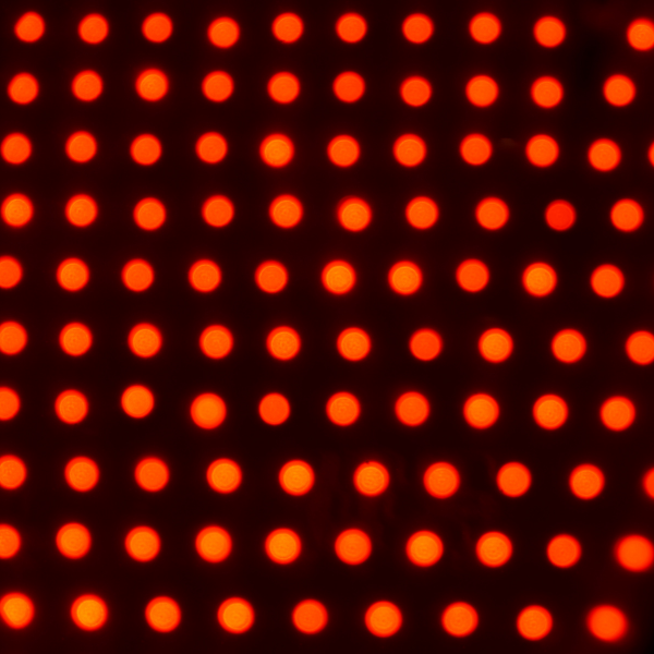 Sandstone Therapeutic Massage / A close up of  red dots that represent red light therapy.