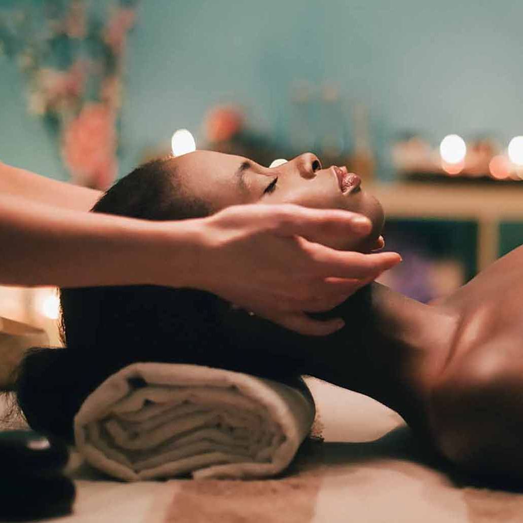 A woman is getting a massage at Sandstone Therapeutic Massage in Novi, MI.