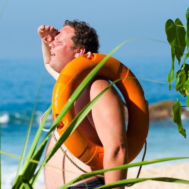 Sandstone Therapeutic Massage / A man with an orange life preserver on his back