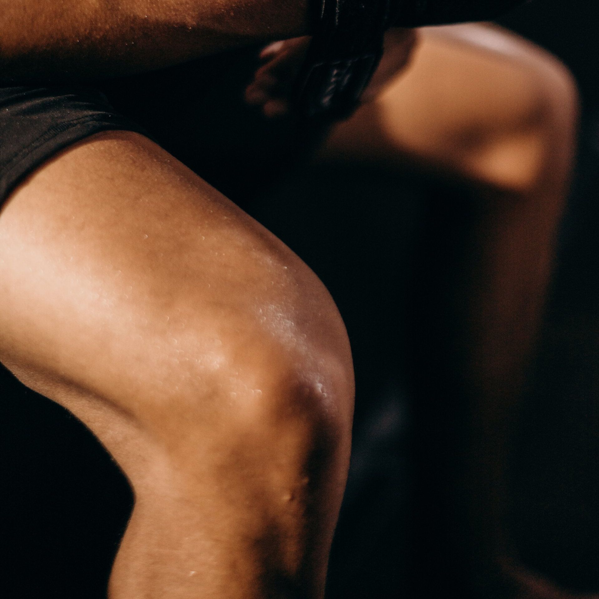 Sandstone Therapeutic Massage / A close-up of a person's knee with sweat on it.