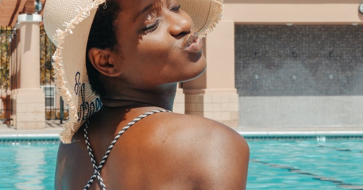 Sandstone Therapeutic Massage / A woman is out in the sun by a pool.